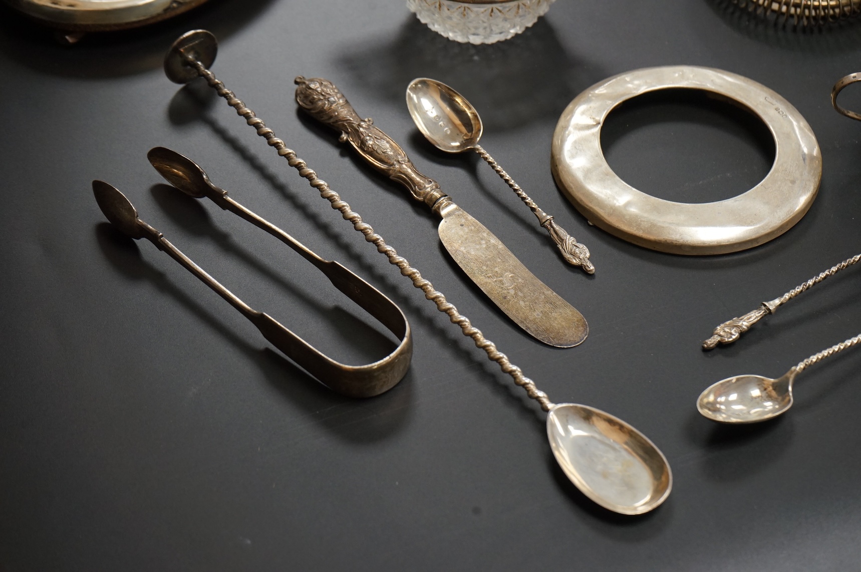 A George V six piece silver condiment set by Mappin & Webb, Birmingham, 1925, two George V silver mounted photograph frames, a small pair of late Victorian silver salts, a silver mounted cut glass dish, a set of six silv
